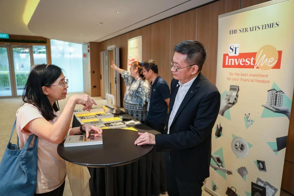 M. Tan Oyboon (à droite), rédacteur en chef des investissements du Straits Times, s'adresse au public après avoir signé des exemplaires de son livre « Retire with more money ».