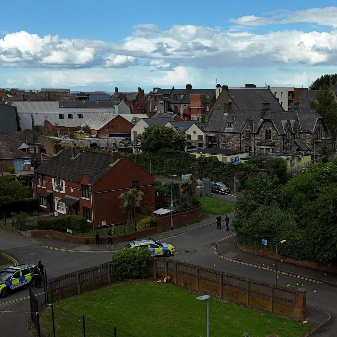 A drone view of police vehicles near a cordon at the scene of a stabbing outside apartments in the Kinnaird Avenue area of north Belfast, after a knife attack on June 8 left a man seriously injured and prompted police to declare a critical incident, in Belfast, Northern Ireland, June 9, 2026. REUTERS/Isabel Infantes