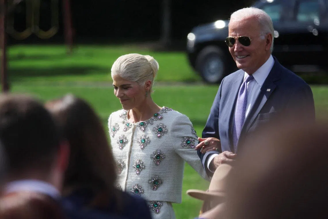 Actress Selma Blair, who has multiple sclerosis, walks arm in arm with Mr Biden at an event to celebrate Americans with disabilities at the White House.
