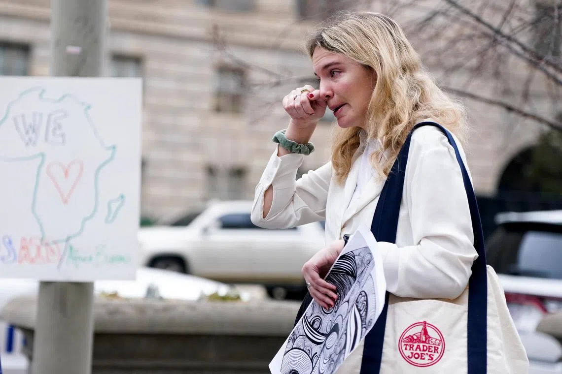 Laid-off probationary employee Juliane Alfen reacts after USAID workers cleared out their desks and collected personal belongings at the agency's headquarters in Washington, on Feb 27.
