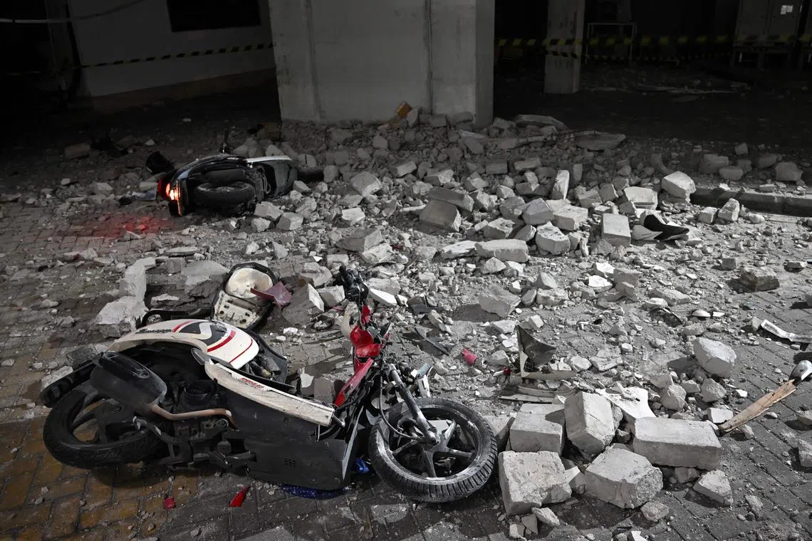 Damaged scooters hit by debris after an earthquake at a carpark at Airlangga University Hospital in Surabaya, Indonesia, on March 22.