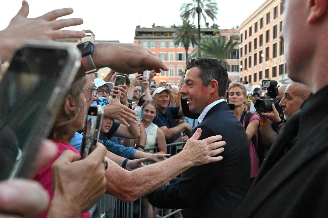 Rory McIlroy of Team Europe greets fans at the bottom of the Spanish Steps in Rome after an official team photo ahead of the 44th Ryder Cup.