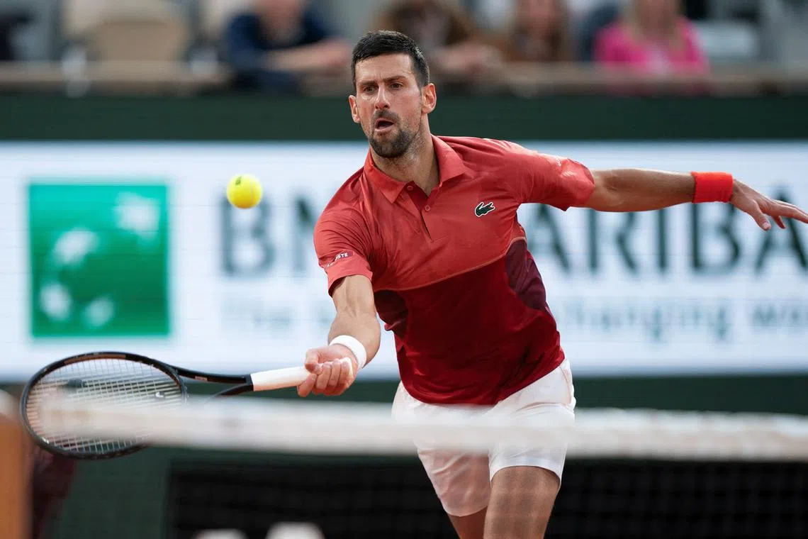 FILE PHOTO: Jun 3, 2024; Paris, France; Novak Djokovic of Serbia returns a shot during his match against Francisco Cerundolo of Argentina on day nine of Roland Garros at Stade Roland Garros. Mandatory Credit: Susan Mullane-USA TODAY Sports/File Photo
