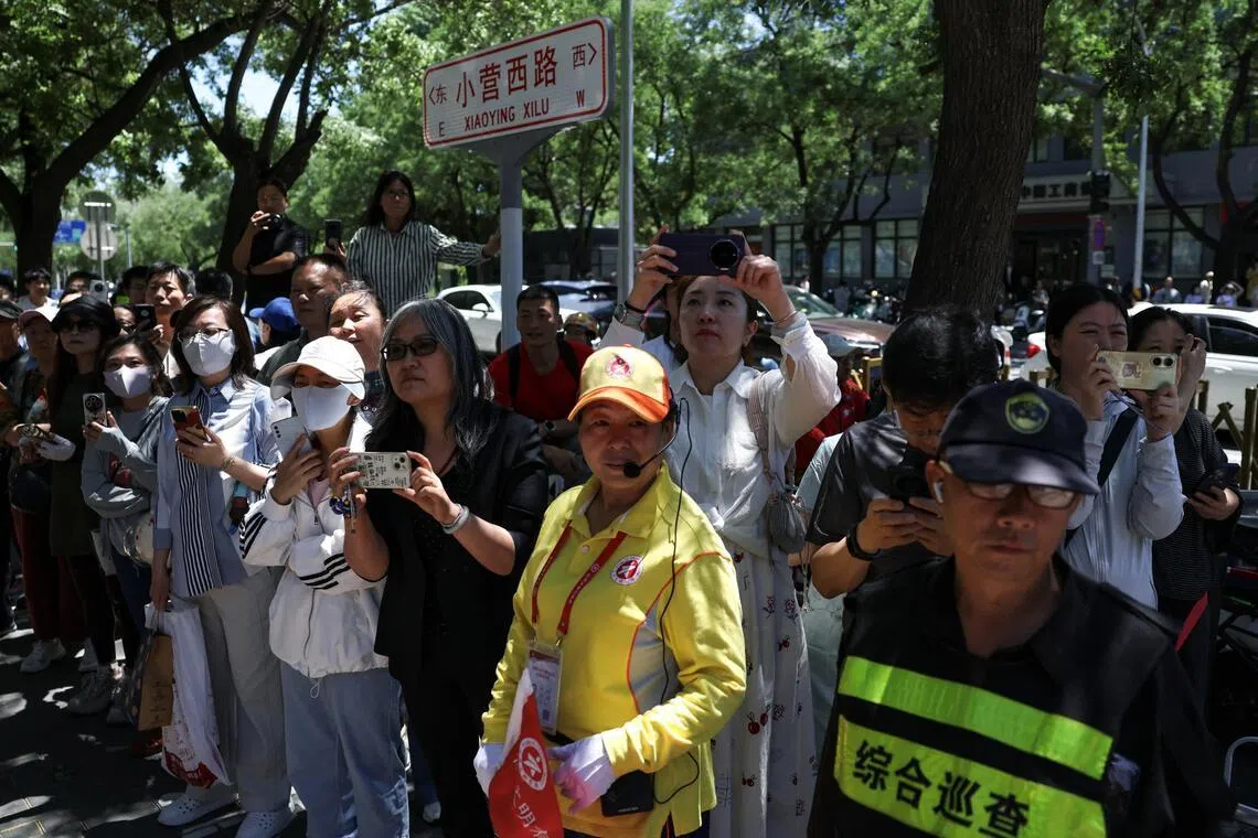 Parents wait outside the venue during the annual “gaokao”, in Beijing on June 7.
