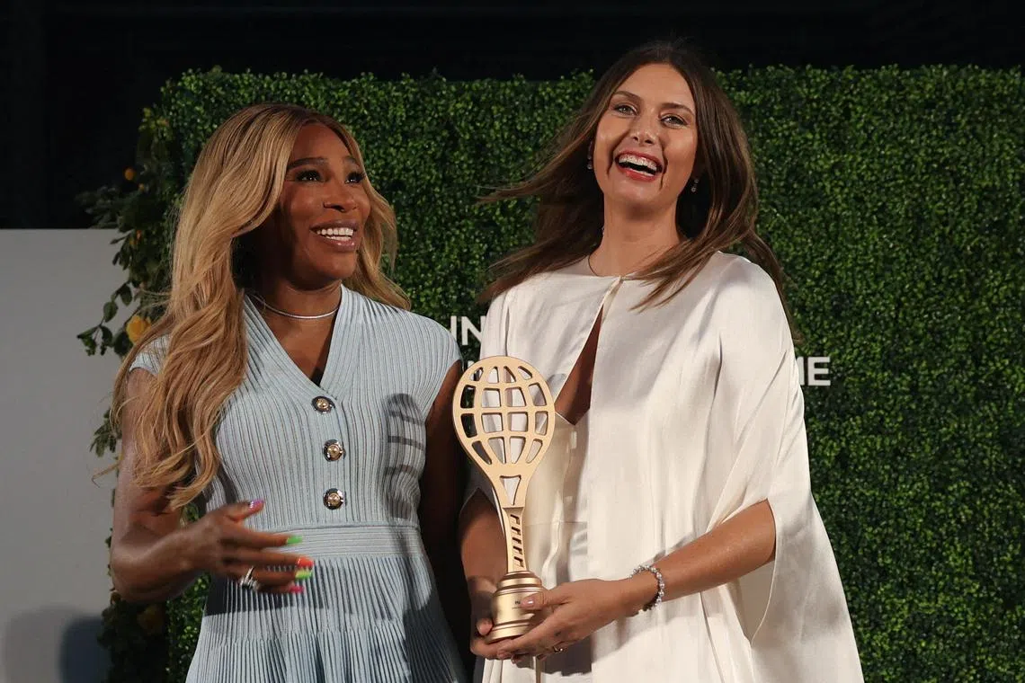Rivals Maria Sharapova and Serena Williams share a laugh during a ceremony to induct Sharapova into the International Tennis Hall of Fame. 