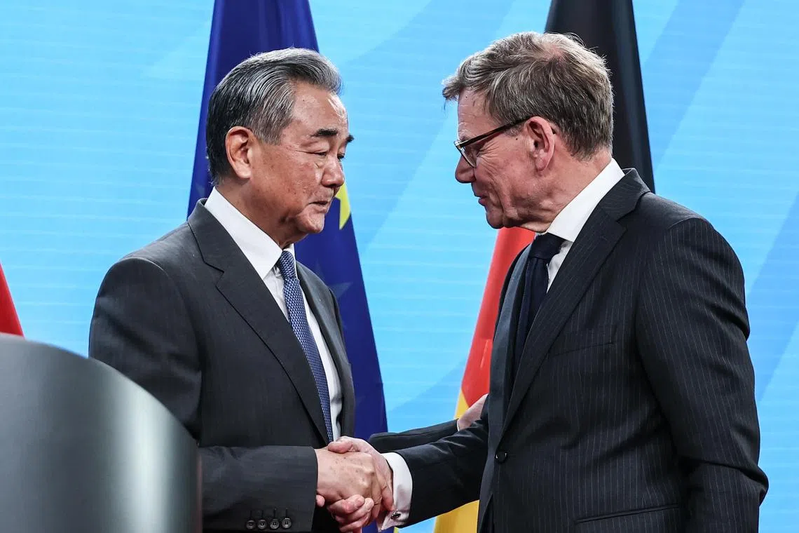 Chinese Foreign Minister Wang Yi (left) and German Foreign Minister Johann Wadephul shaking hands after a joint press conference in Berlin, on July 3.