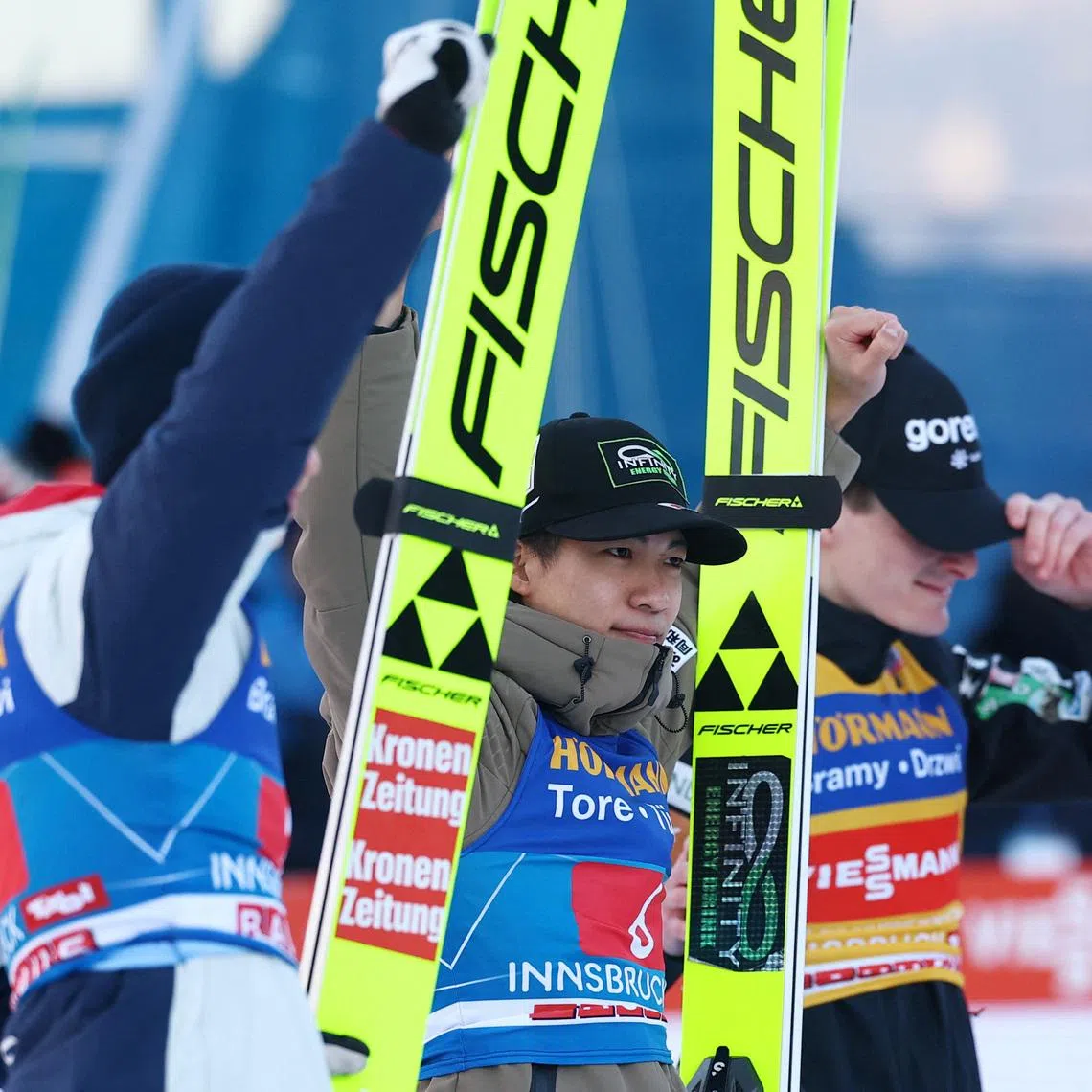 Ski Jumping - Four Hills Tournament - Innsbruck, Austria - January 4, 2026 Japan's Ren Nikaido celebrates after winning the Men's Individual HS128 alongside second place Slovenia's Domen Prevc and third place Austria's Stephan Embacher REUTERS/Kai Pfaffenbach