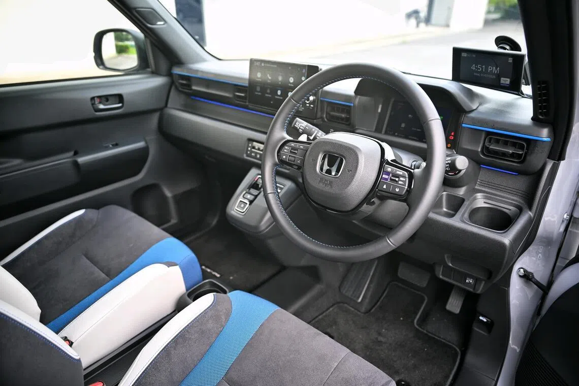 Familiar fascia: The cockpit is similar to what you see in recent Honda models, except for old-school air-conditioning vents and compact packaging.