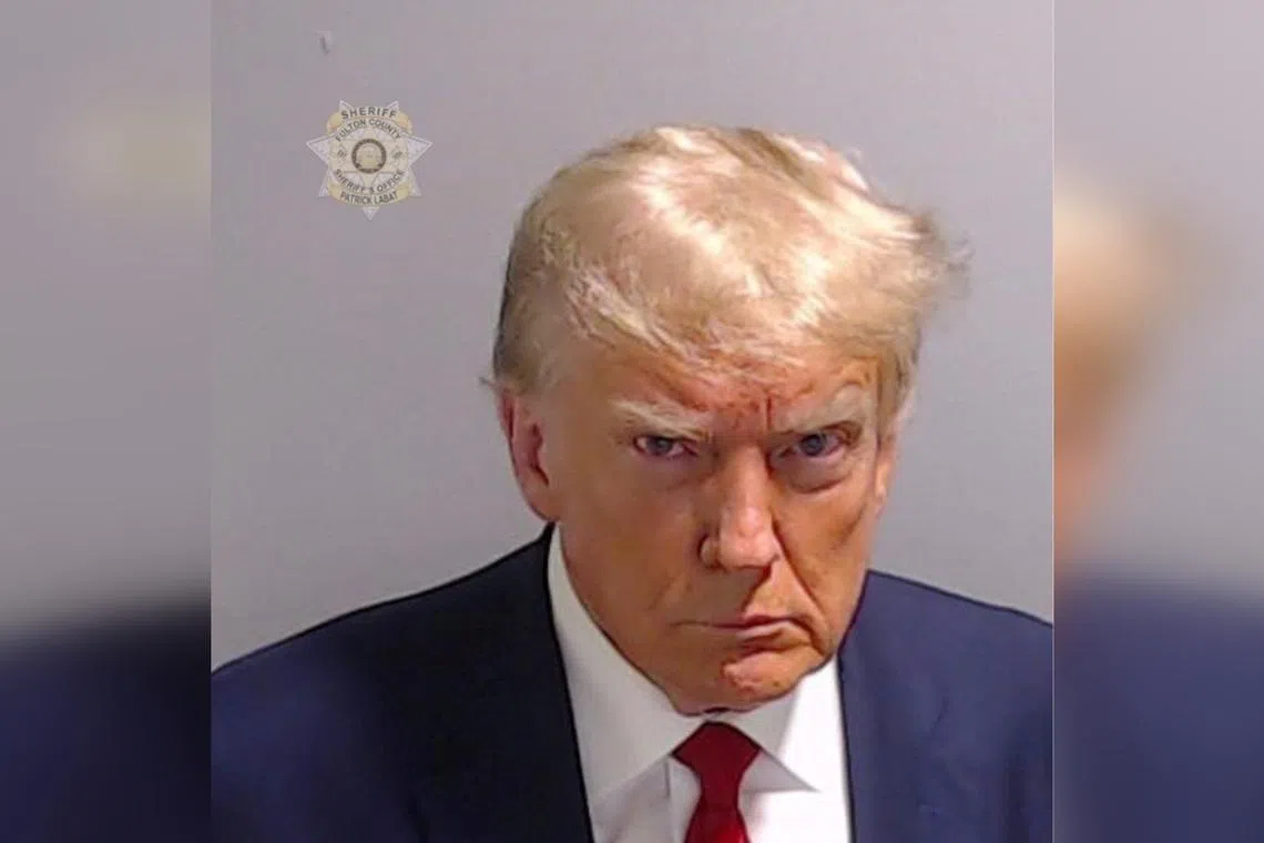 Former US president Donald Trump is shown in a police booking mugshot released by the Fulton County Sheriff's Office on Aug 24.
