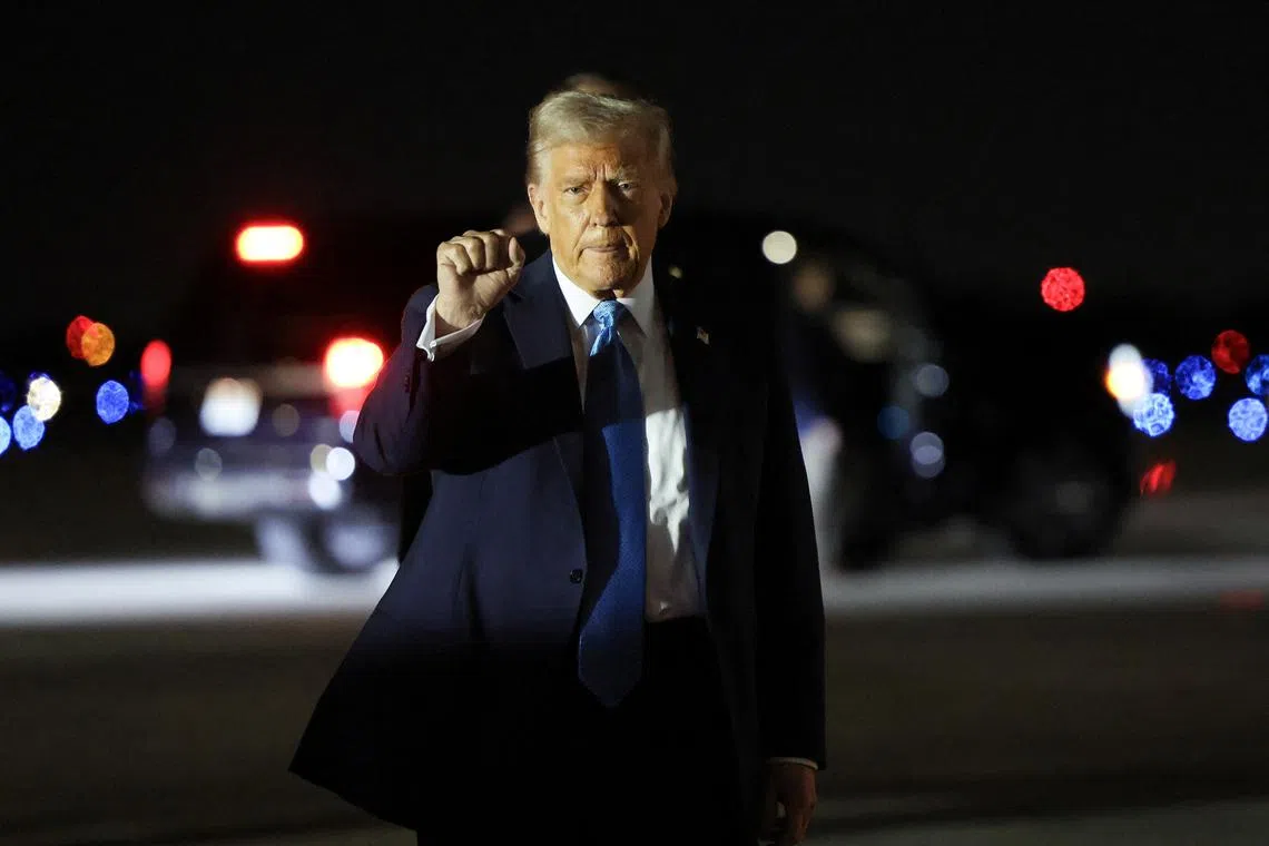 U.S. President Donald Trump pumps his fist upon his arrival in West Palm Beach, Florida, U.S., January 31, 2025. REUTERS/Kevin Lamarque