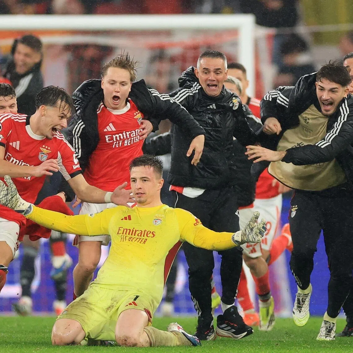 Benfica's Ukrainian goalkeeper Anatoliy Trubin celebrates after scoring his team's fourth goal during the UEFA Champions League match at the Estadio da Luz in Lisbon.
