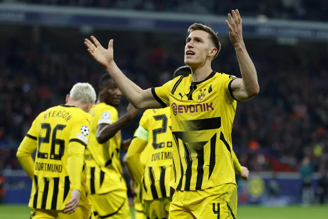 Soccer Football - Champions League - Round of 16 - Second Leg - Lille v Borussia Dortmund - Decathlon Arena Stade Pierre-Mauroy, Villeneuve-d'Ascq, France - March 12, 2025 Borussia Dortmund's Nico Schlotterbeck celebrates their first goal scored by Emre Can REUTERS/Stephanie Lecocq/ File Photo