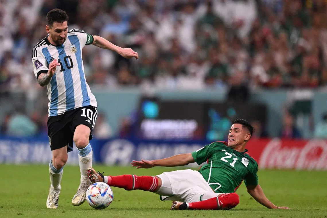 Argentina captain Lionel Messi evading the challenge of Mexico's Uriel Antuna during a World Cup Group C match  on Saturday. Argentina won 2-0.
