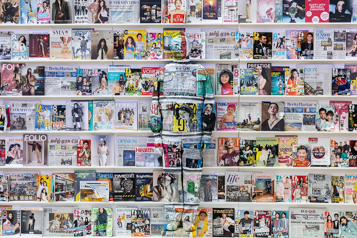 ST20250914_202513400350/pixliubolin/Brian Teo/Beijing-based contemporary artist Liu Bolin is photographed against a backdrop of SPH Media newspapers and magazines during the Canvas of Hope initiative by the Rare Disorders Society (Singapore) [RDSS] at the Glass Dome, Far East Square, on Sept 14, 2025. The art-meets-advocacy campaign, Liu’s first collaboration with a Singapore charity, aims to spotlight the lives of children with rare diseases and raise S$1 million for therapy, medical equipment and caregiving support for over 200 patients. For Canvas of Hope 2025, a Singapore chapter was created using The Straits Times and other SPH titles, marking both The Straits Times’ 180th anniversary and Singapore’s 60th year of independence. The artwork honours the media’s role in chronicling the nation’s stories while prompting reflection on which narratives are visible and which remain unseen. ST PHOTO: BRIAN TEO