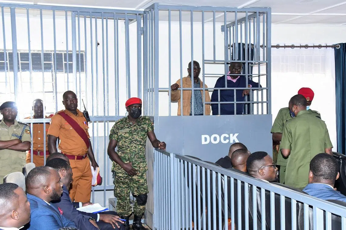 FILE PHOTO: Opposition leader Kizza Besigye and Obeid Lutale stand in a steel dock at the Uganda Military General Court Martial in Makindye, a suburb of Kampala, Uganda December 2, 2024. REUTERS Abubaker Lubowa/File Photo