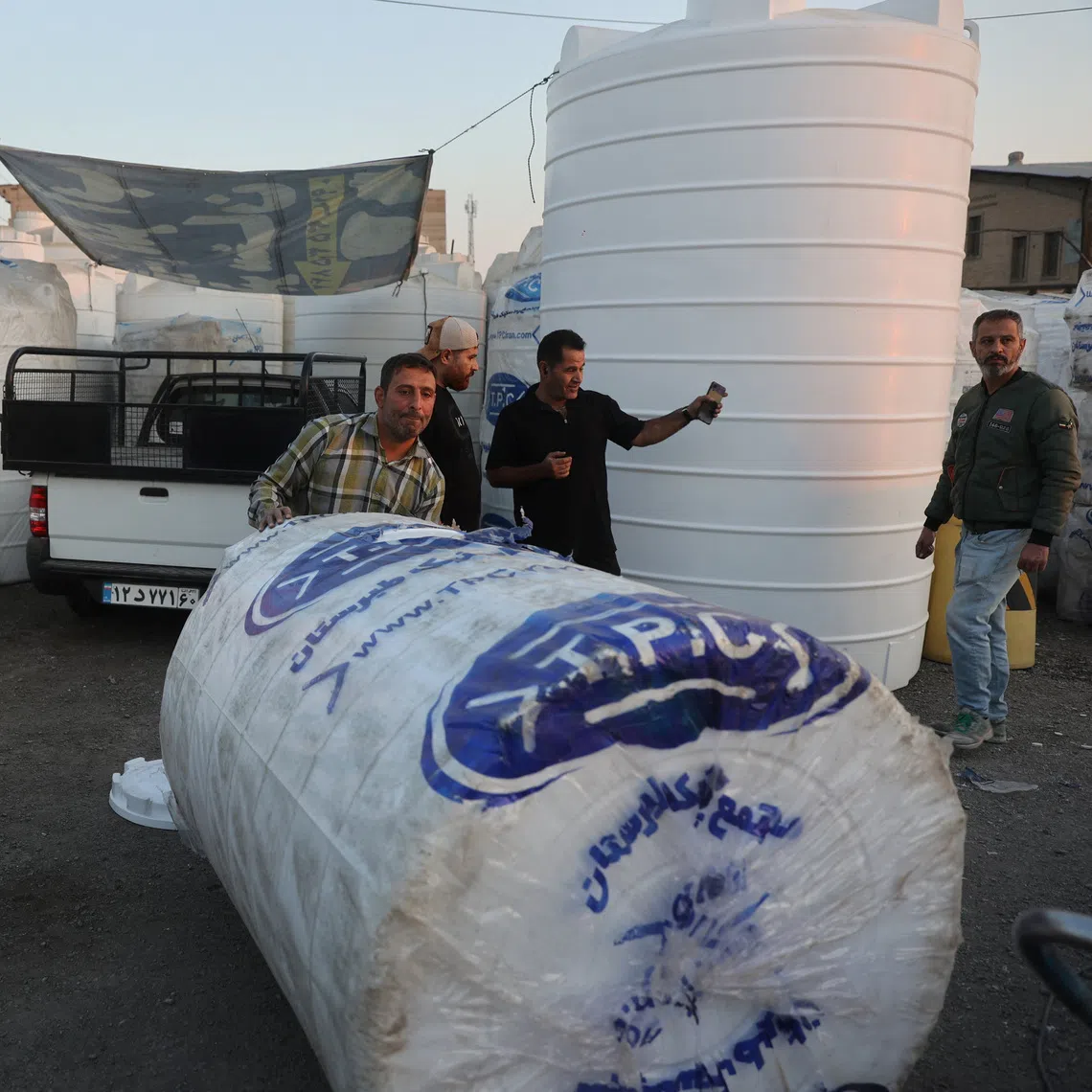 People shopping for water storage tanks during a drought crisis in Tehran on Nov 10.