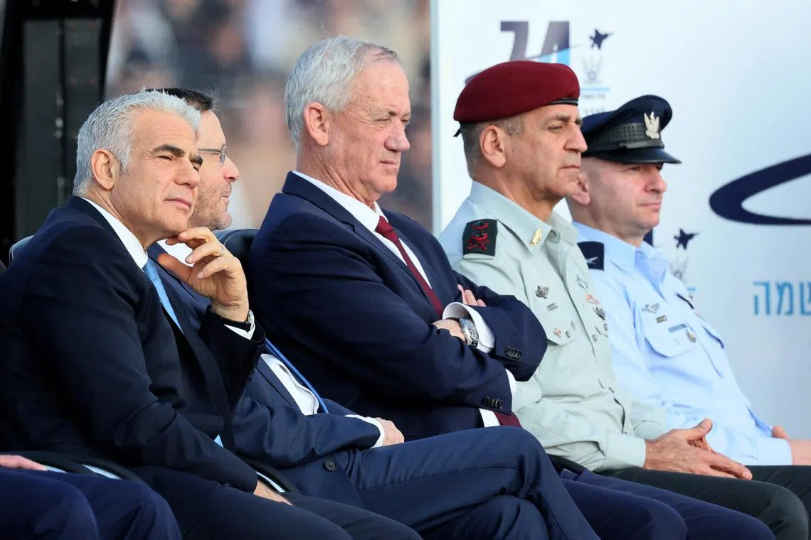 (From left) Israel's Prime Minister Yair Lapid, President Isaac Herzog and Defence Minister Benny Gantz attend a graduation ceremony for Israeli Air Force pilots, on Dec 28, 2022.