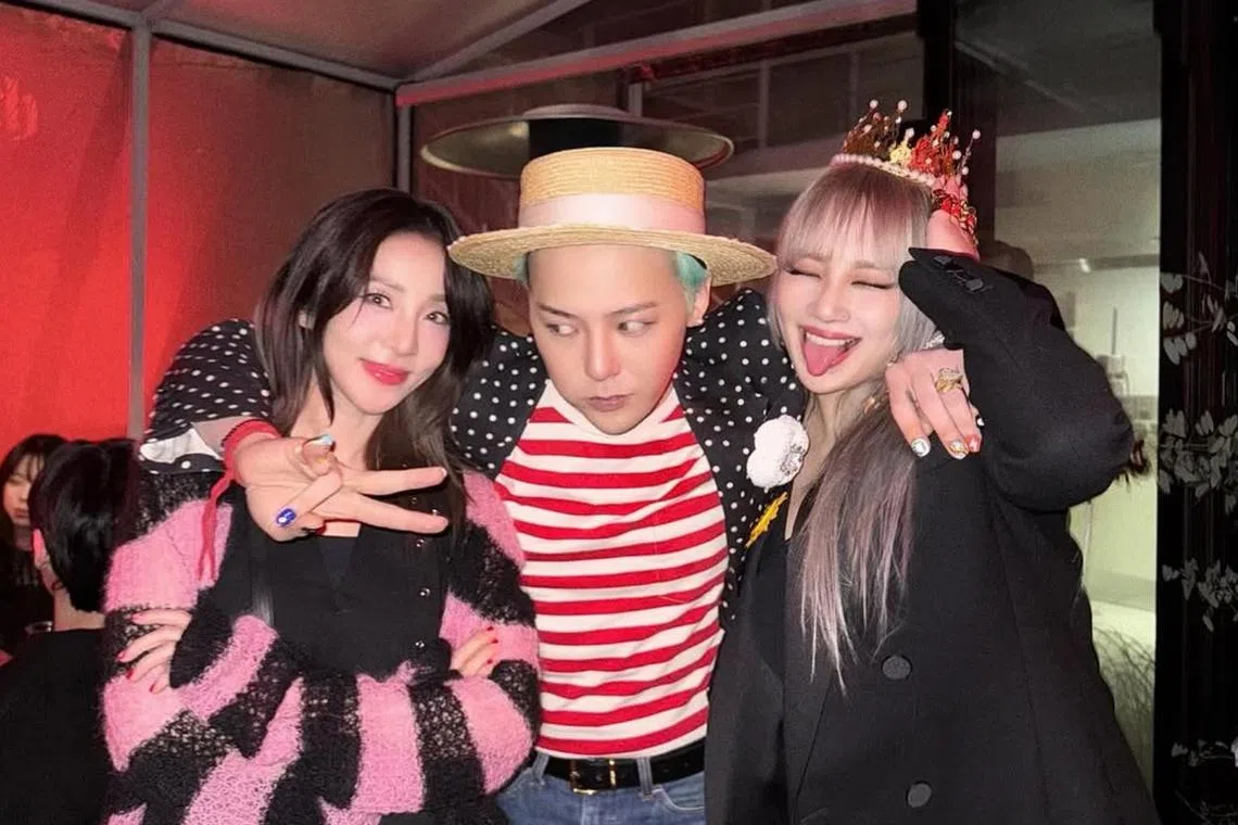 K-pop star G-Dragon (centre) with girl group 2NE1 members Dara (left) and CL (right) at the listening party for his new album Ubermensch, on Feb 25.