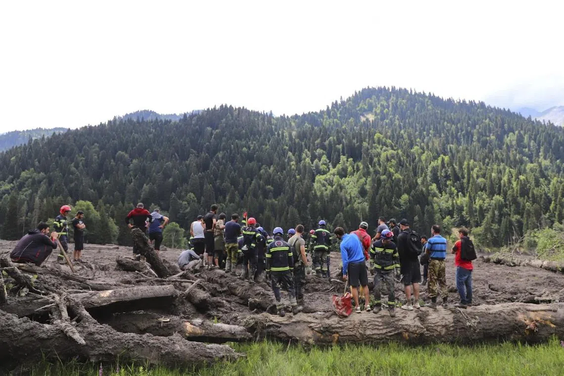 Rescuers search for survivors a day after the Aug 3 disaster in rural Shovi, Georgia