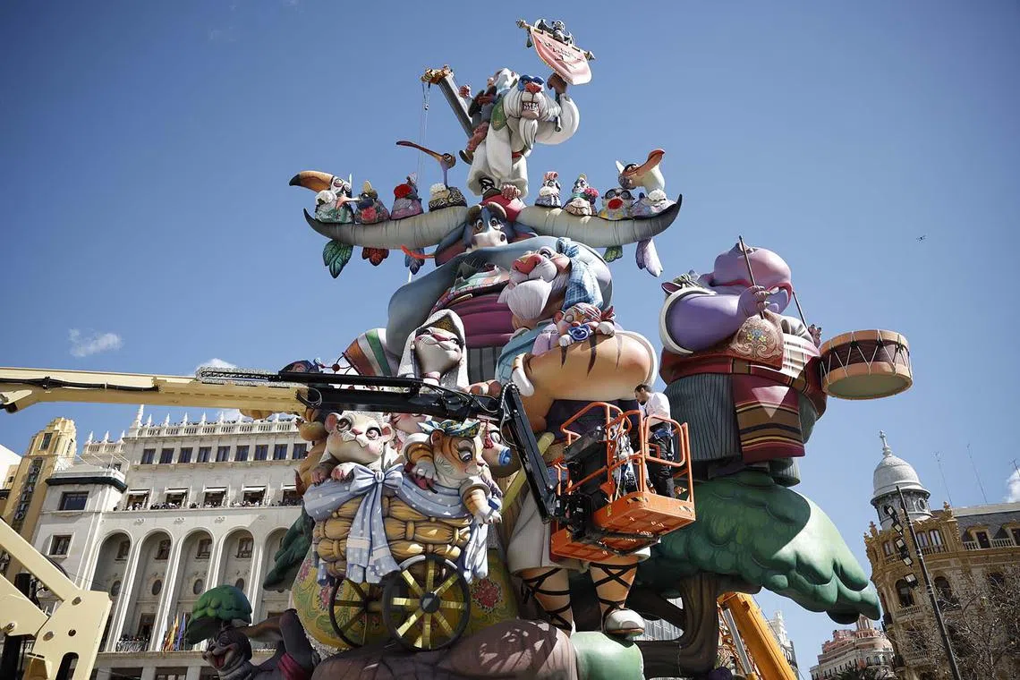 Artists working on a falla in Valencia, Spain, March 12, 2025. The Fallas festival is a fortnight-long fiesta featuring installations of parodic papier-mache, cardboard, and wooden sculptures that parody both fictitious and real people and situations. These sculptures decorate the streets and are traditionally burned on the last day of the event (March 19) during the 'Crema' to mark the end of the festivities, except for one, which is 'saved' by the public and taken to the Fallas Museum. 