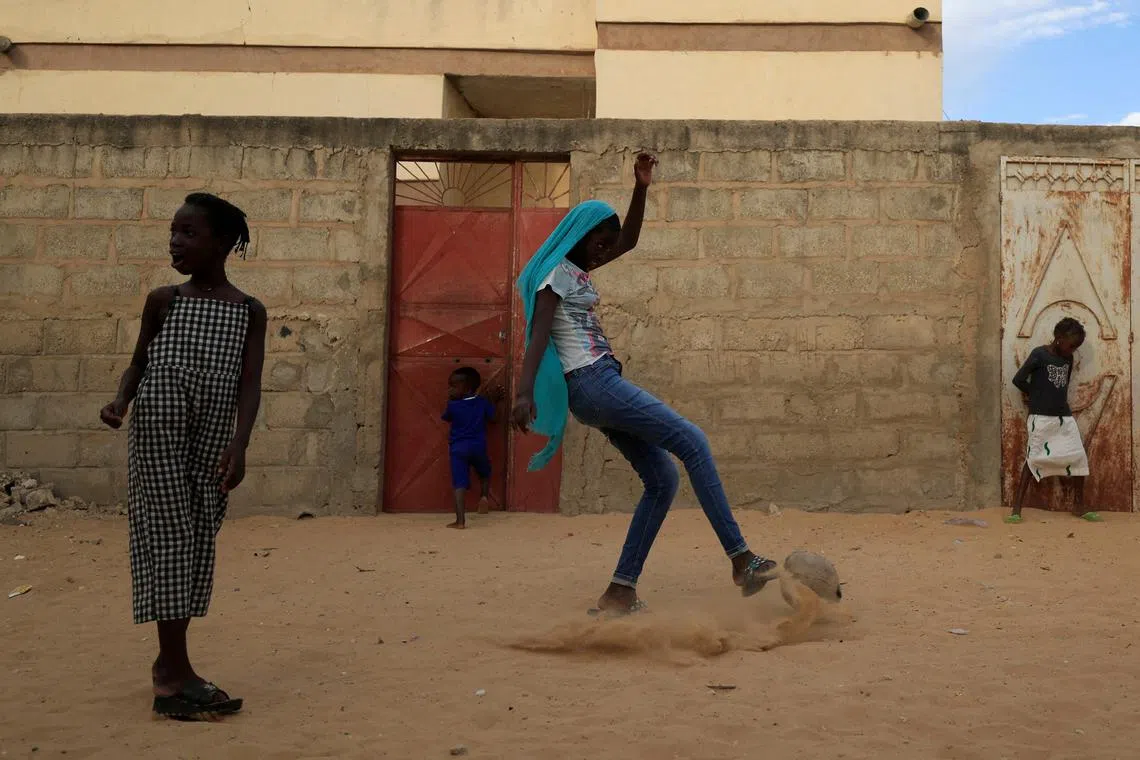 Maty Diop plays soccer outside her house, on the outskirts of Dakar, Senegal, Jan 17, 2023. 