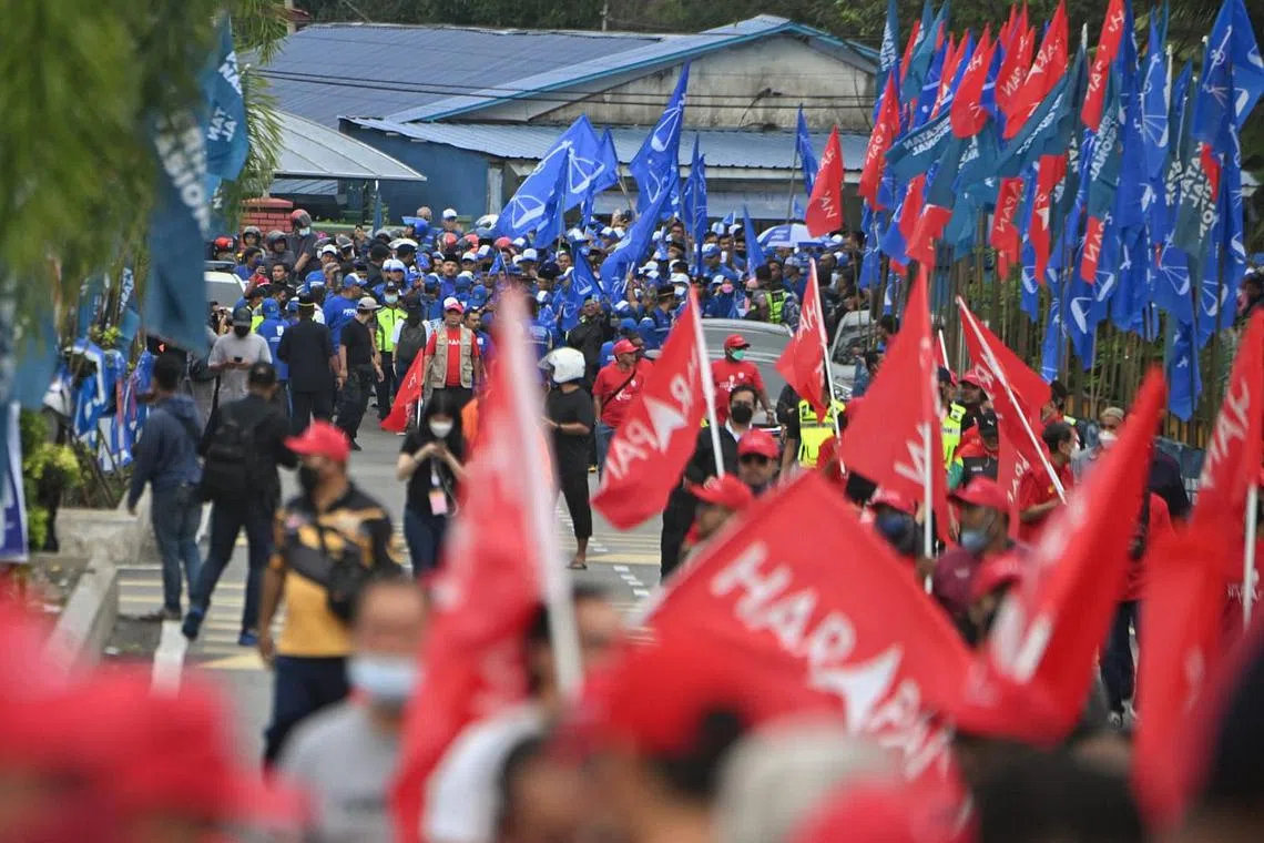 Barisan Nasional and Pakatan Harapan supporters waving flags in Gombak, Selangor on Nomination Day. 