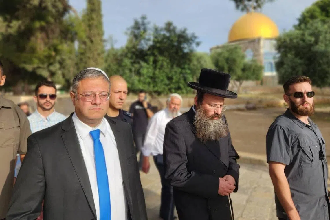 A handout picture courtesy of Minhelet Har-Habait (Temple Mount Administration) shows Israel's National Security Minister Itamar Ben-Gvir (L) walking through the courtyard of Jerusalem's Al-Aqsa mosque complex, known to Jews as the Temple Mount, early on May 21, 2023. The controversial move by the extreme-right politician came amid heightened tensions in annexed east Jerusalem, after he and tens of thousands of Jewish nationalists marched through the Old City and just over a week into a fragile Gaza ceasefire. (Photo by Minhelet Har-Habait (Temple Mount Administration) / AFP) / RESTRICTED TO EDITORIAL USE - MANDATORY CREDIT "AFP PHOTO /Minhelet Har-Habait (TEMPLE MOUNT ADMINISTRATON)  - NO MARKETING NO ADVERTISING CAMPAIGNS - DISTRIBUTED AS A SERVICE TO CLIENTS