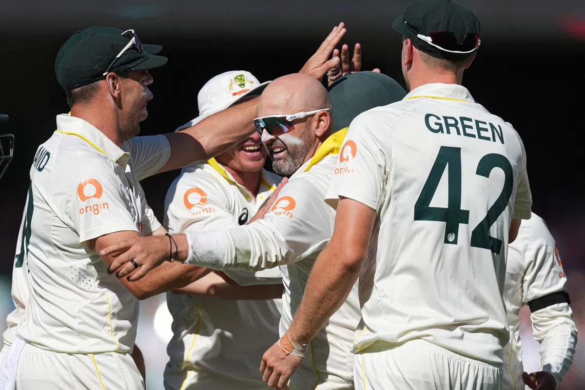 Cricket - The Ashes - Australia v England - Third Test - Adelaide Oval, Adelaide, Australia - December 20, 2025 Australia's Nathan Lyon celebrates with teammates after taking the wicket of England's Zak Crawley REUTERS/Asanka Brendon Ratnayake
