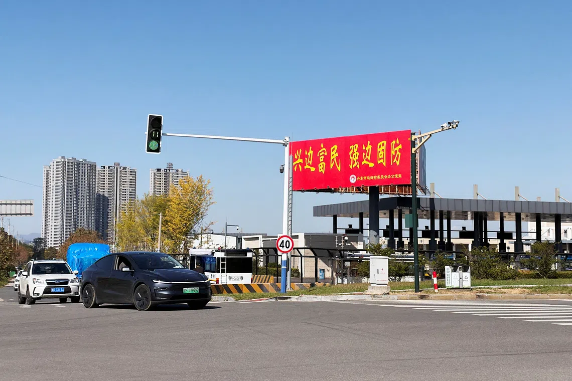 Vehicles travel past the Chinese customs facility for the New Yalu River Bridge, which is designed to link North Korea’s Sinuiju with China’s Dandong New Zone.