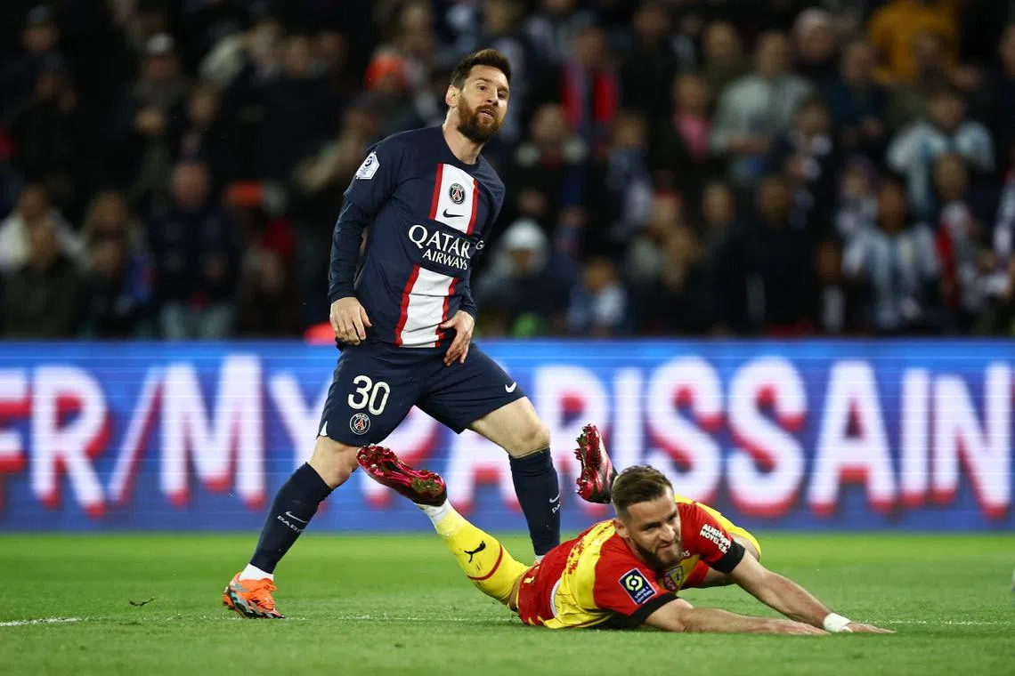 Lens' goalkeeper Brice Samba dives but fails to stop a goal by Paris Saint-Germain's forward Lionel Messi.