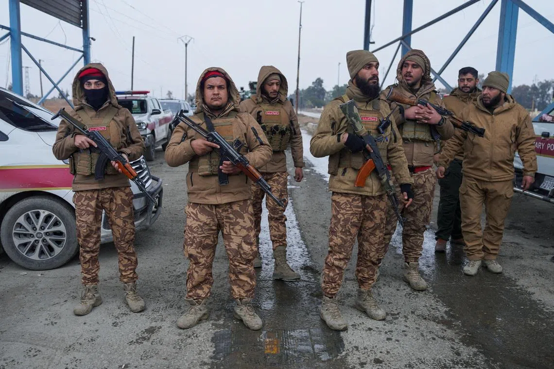 FILE PHOTO: Members of the Syrian military police gather outside al-Aqtan prison, where some Islamic State detainees are held, in Raqqa, Syria January 22, 2026. REUTERS/Karam al-Masri/File Photo