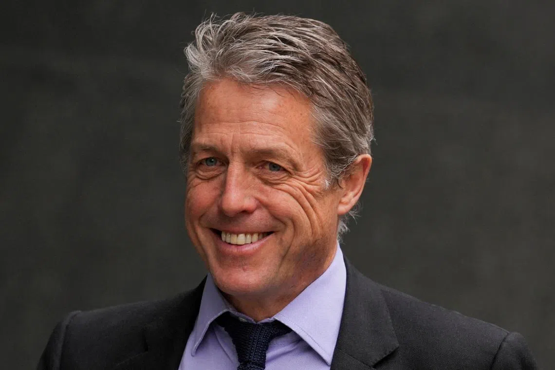 Hugh Grant walks outside the High Court, in London on April 27, 2023. 