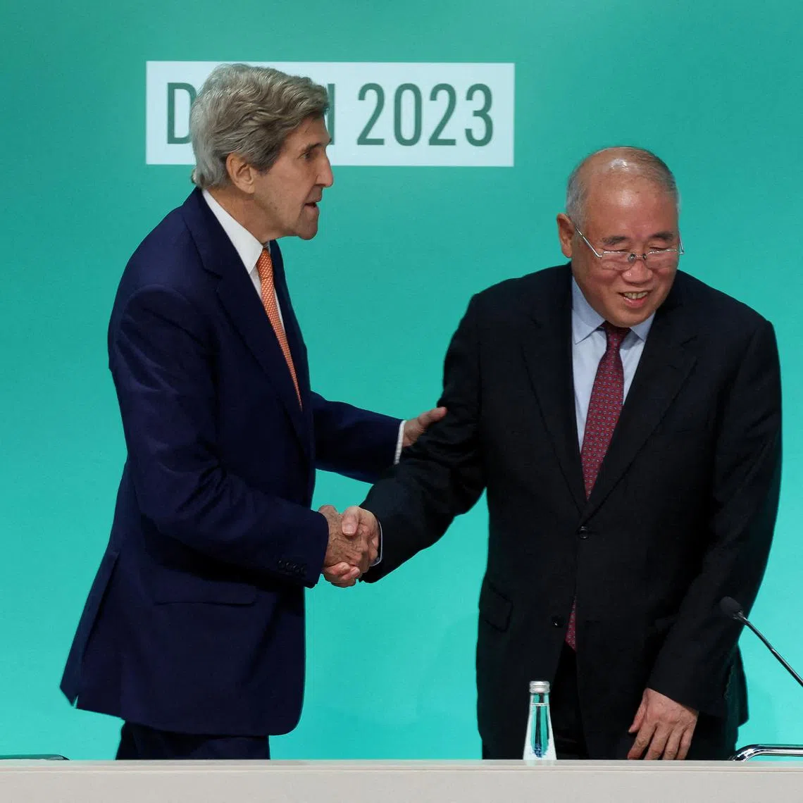 FILE PHOTO: U.S. Climate Envoy John Kerry and Chinese Climate Envoy Xie Zhenhua shake hands at a press conference, after a draft of a negotiation deal was released, at the United Nations Climate Change Conference COP28 in Dubai,  United Arab Emirates, December 13, 2023. REUTERS/Amr Alfiky/File Photo