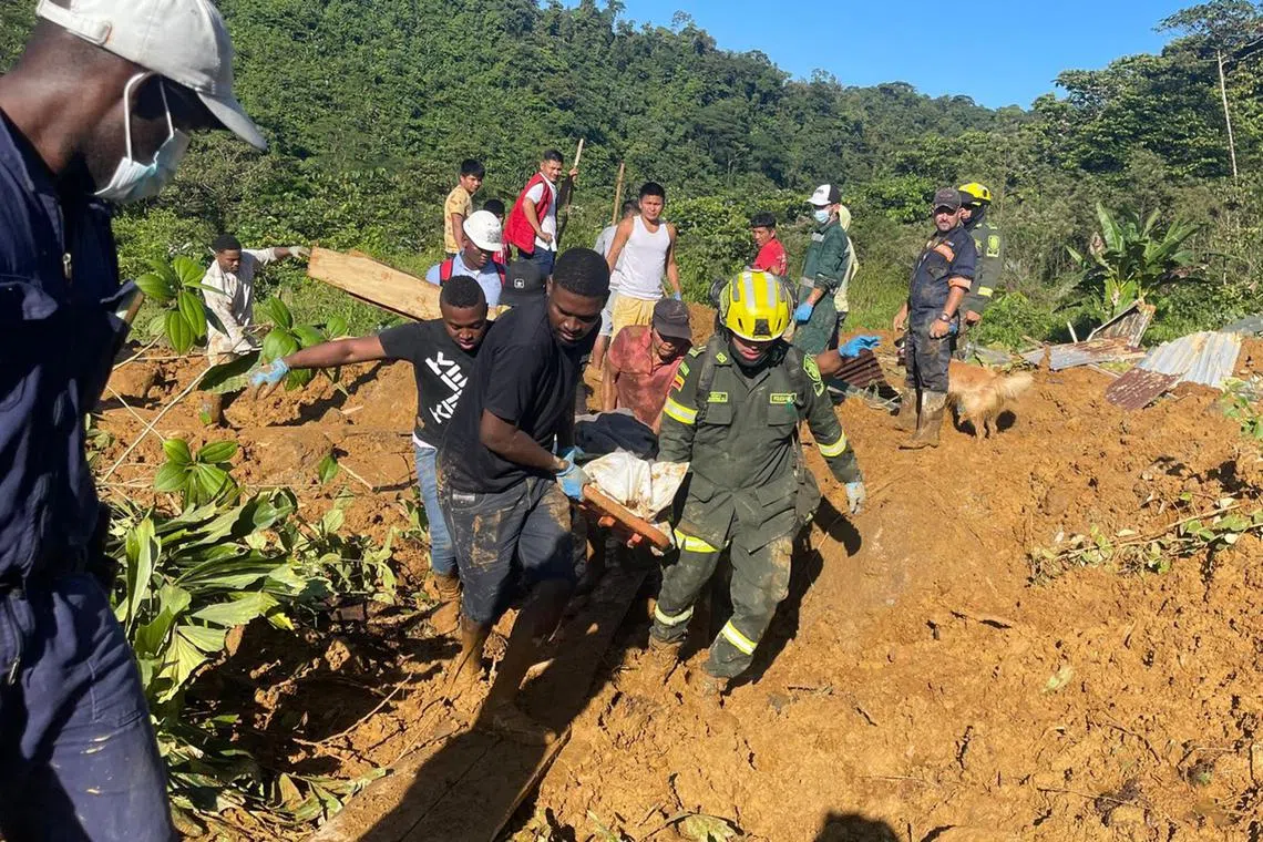 Rescue workers remove a body from the site of the disaster, in northwestern Colombia.