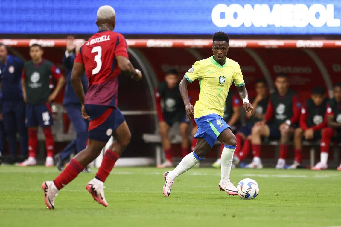 Jun 24, 2024; Inglewood, CA, USA; Brazil forward Vinícius Júnior (7) dribbles against Costa Rica defender Jeyland Mitchell (3) during the first half of a match at SoFi Stadium. Mandatory Credit: Jessica Alcheh-USA TODAY Sports