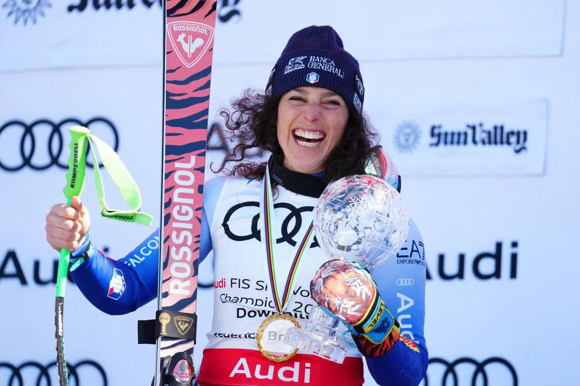 Mar 22, 2025; Sun Valley, ID, USA; Overall downhill points leader Federica Brignone of Italy celebrates with the crystal globe on the podium after the 2025 FIS Ski World Cup finals at Sun Valley. Christopher Creveling-Imagn Images