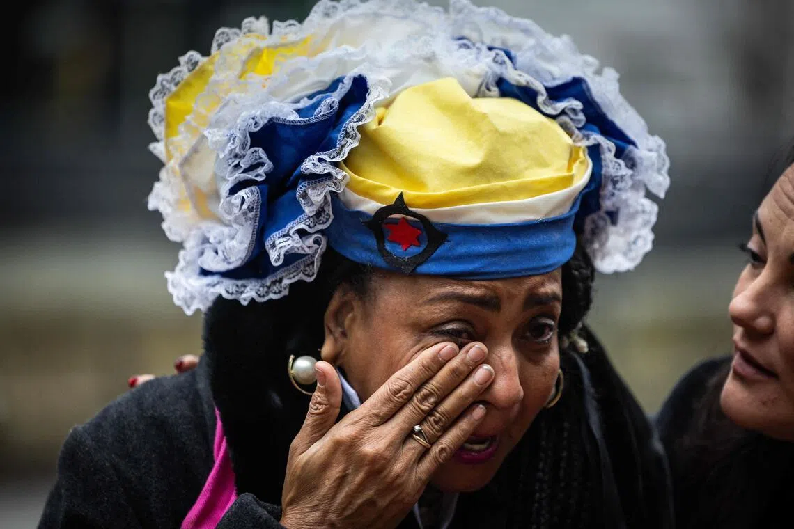 A resident of the Dutch territory of Bonaire - off Venezuela - weeping outside the court, after the Dutch government was ordered to do more to protect the island from the effects of climate change.  