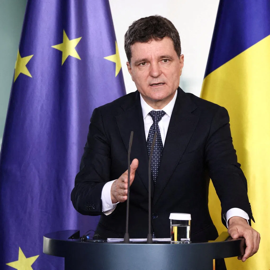 FILE PHOTO: Romanian President Nicusor Dan speaks during a press conference with German Chancellor Friedrich Merz (not pictured), in Berlin, Germany, July 18, 2025. REUTERS/Liesa Johannssen/File Photo