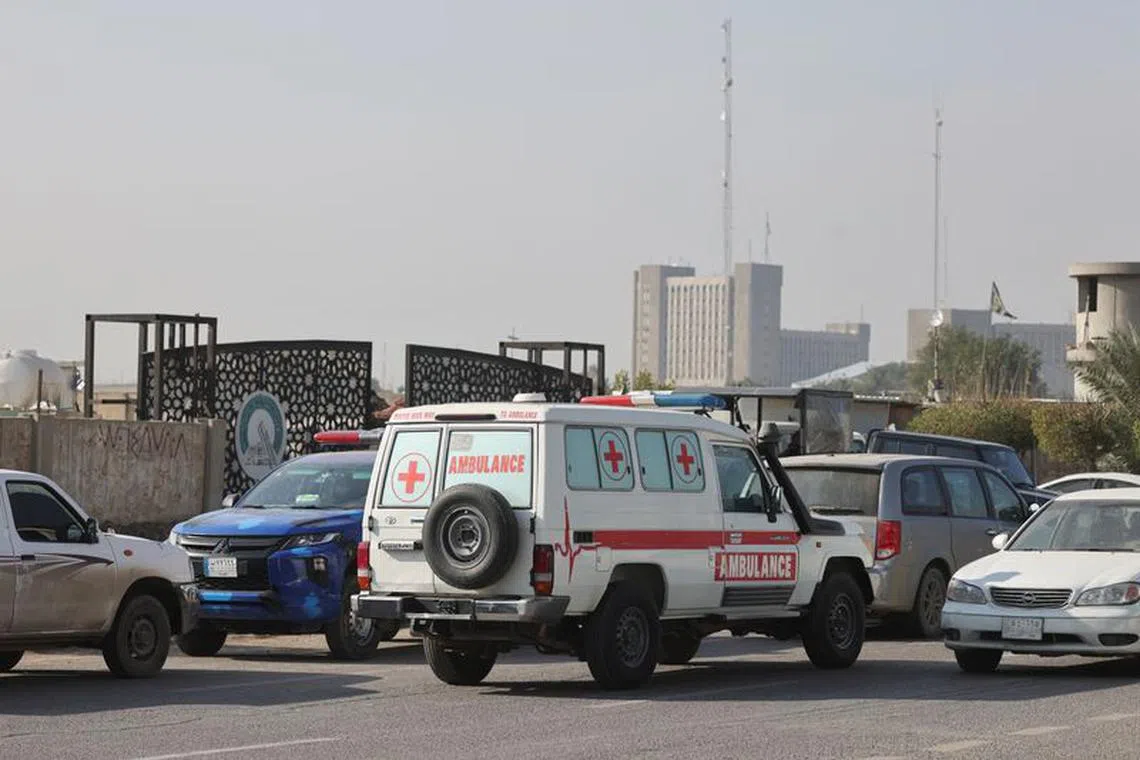 FILE PHOTO: Iraqi ambulance is parked next to a police vehicle at a street after an attack by a drone strike on an Iran-backed militia headquarters in Baghdad, Iraq January 4, 2024. REUTERS/Ahmed Saad/File Photo