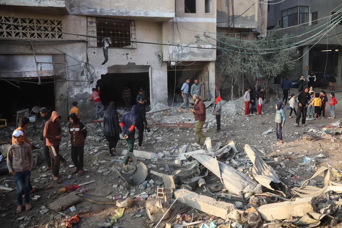 Palestinians checking the damage after an Israeli air strike on Dec 12, near the Nuseirat refugee camp in the central Gaza Strip.