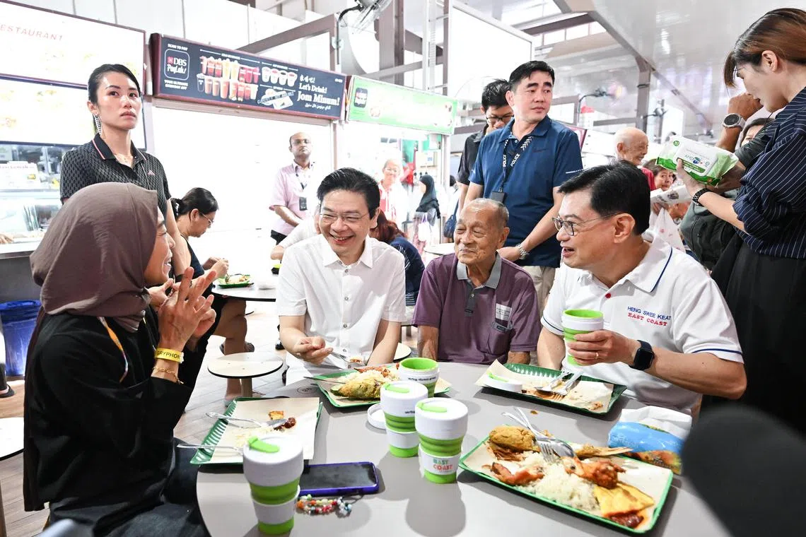 ST20241214-202437100803-Lim Yaohui-Shermaine Ang-smbedok14/
Prime Minister Lawrence Wong and Deputy Prime Minister Heng Swee Keat having nasi lemak breakfast with stall owners of Azman Seafood Restaurant Madam Linah Tay Binte Azman, (extreme left) 48, and Mr Azman Bin Abdullah @ Tay Ah Tee, 85, at Blk 58 New Upper Changi Road hawker centre on Dec 14, 2024.
(ST PHOTO: LIM YAOHUI)