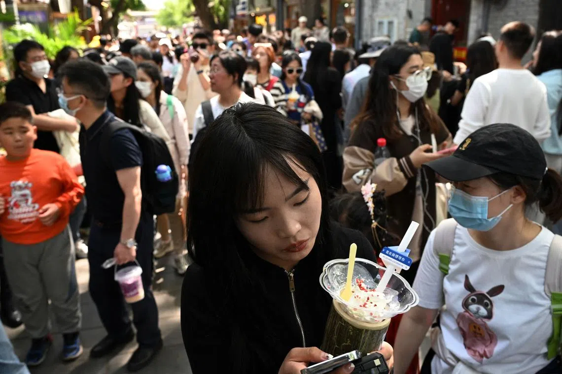 Shoppers were out in force in a crowded alley in Beijing on April 29, 2023.