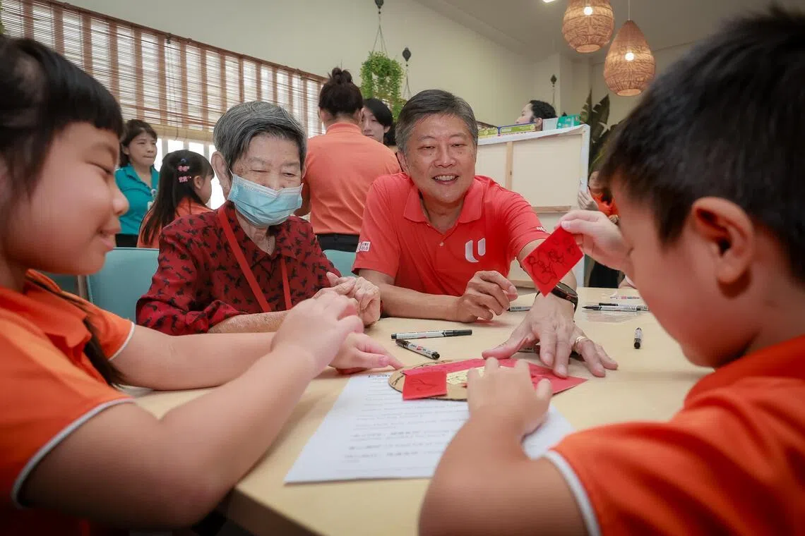 NTUC Secretary-General Ng Chee Meng, together with children from My First Skool at Braddell Heights Community Hub and seniors from NTUC Health Segangoon Central, penning wishes during the launch of the NTUC Community Fund on April 9, 2026.