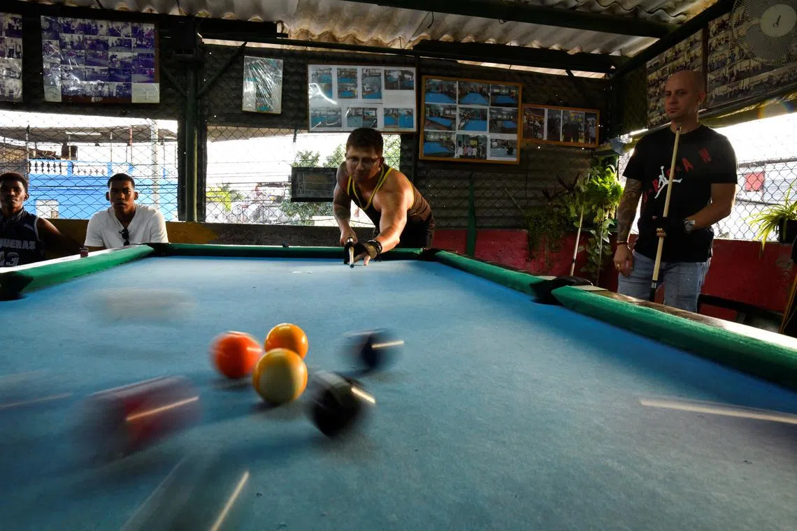 Students play pool at a billiards academy in Havana, Cuba February 17, 2025.  REUTERS/Norlys Perez