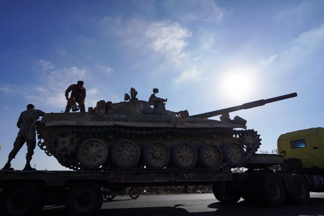 A member of the Syrian security forces stands on a military vehicle after Syrian troops entered the predominantly Druze city of Sweida on Tuesday following two days of clashes, in Sweida, Syria July 15, 2025. REUTERS/Karam al-Masri