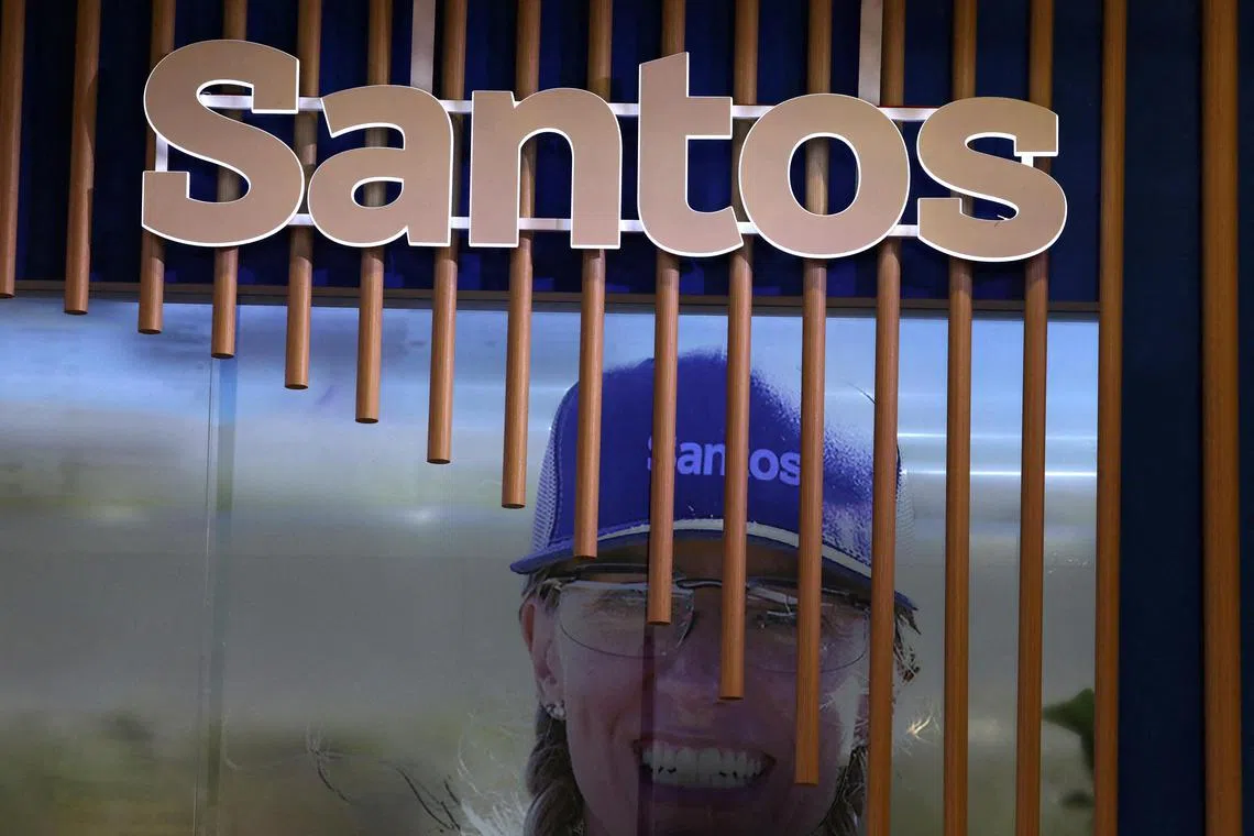 FILE PHOTO: The logo of Australian oil and gas exploration and production company Santos is displayed during the LNG 2023 energy trade show in Vancouver, British Columbia, Canada, July 12, 2023. REUTERS/Chris Helgren/File Photo