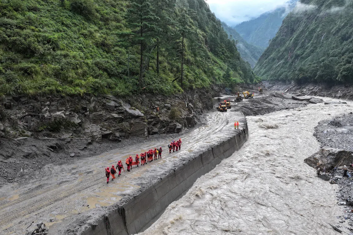 A drone view of firefighters conducting search and rescue operations at a damaged road leading to Gyirong Port after a mudslide, in Gyirong county, Shigatse, Tibet Autonomous Region, China August 28, 2026. cnsphoto via REUTERS