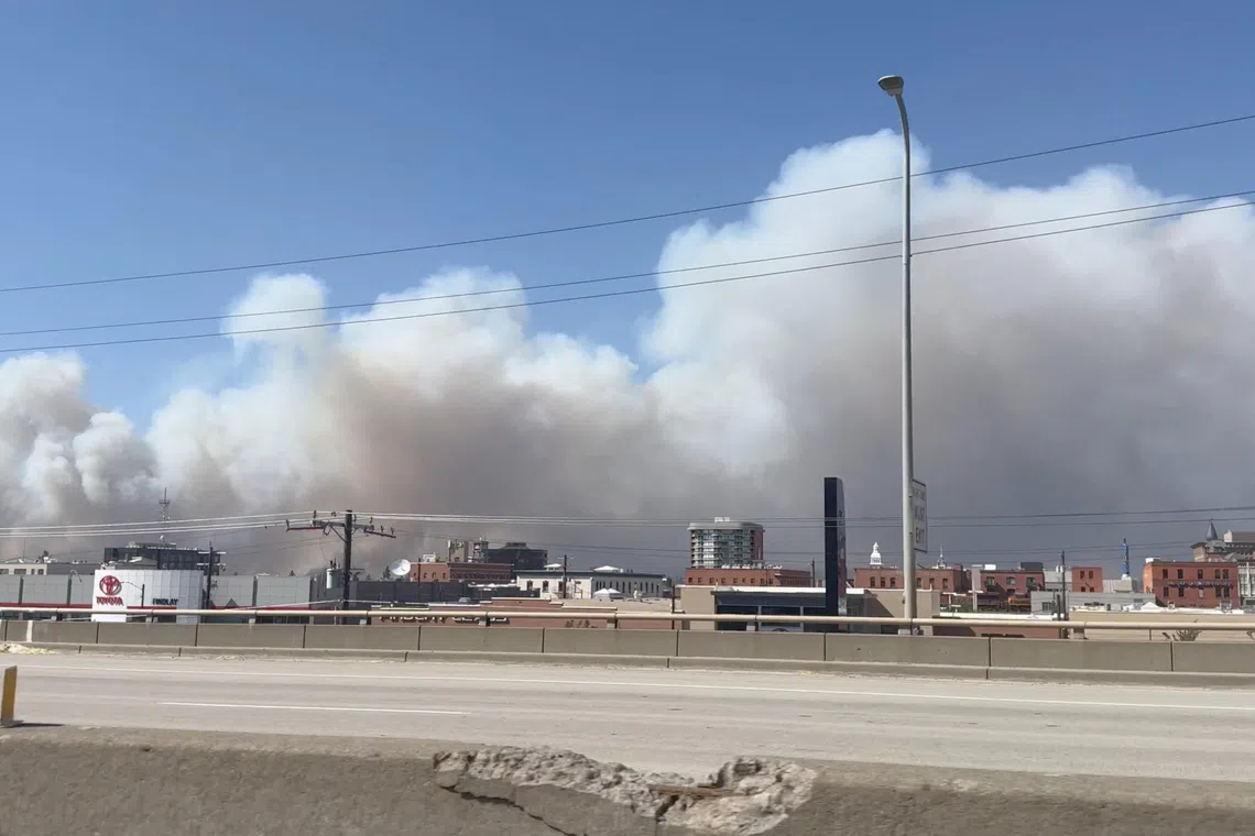 Massive plumes of smoke rise over the US city of Spokane due to wildfires.