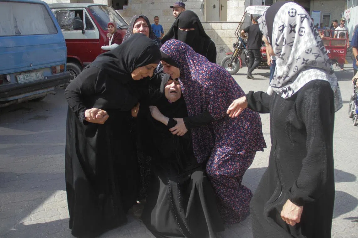 Palestinians mourning the victims of an Israeli strike on a school in Gazag City on Aug 10.