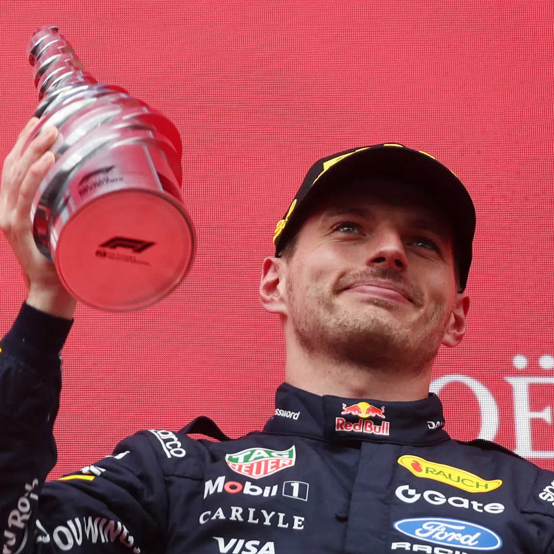 FILE PHOTO: Formula One F1 - Belgian Grand Prix - Circuit de Spa-Francorchamps, Stavelot, Belgium - July 19, 2026 Red Bull's Max Verstappen celebrates with a trophy on the podium after finishing third place in the Belgian Grand Prix REUTERS/Jakub Porzycki/File Photo